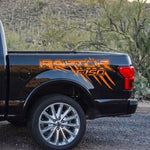 Glossy orange claw scratch bed side decal on Ford F-150 Raptor